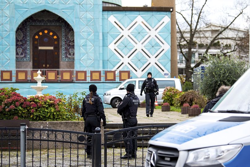 Police officers stand in front of the Imam Ali Mosque (Blue Mosque) on the Outer Alster during a raid on the Islamic Centre in Hamburg.