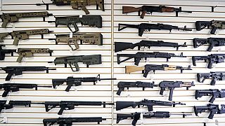 FILE - In this photo taken Oct. 2, 2018, semi-automatic rifles fill a wall at a gun shop in Lynnwood in the United States.