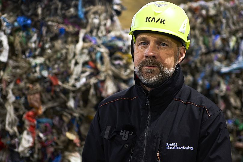 Mattias Philipsson, CEO of Swedish Plastic Recycling poses in front of plastic waste, stored in a new plastic waste sorting facility in Motala, central Sweden.