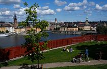 People enjoy sunny weather in a park in Stockholm, Sweden.