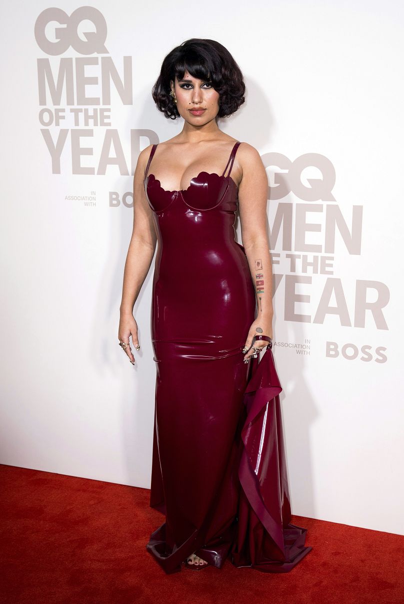 RAYE poses for photographers upon arrival at the GQ Men of the Year Awards in London, Wednesday, Nov. 15, 2023.