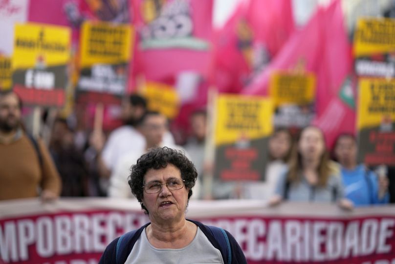 Demonstrators carry banners and flags during a protest by workers' unions demanding, among other things, an increase of salaries and pensions, in Lisbon, Nov. 11, 2023