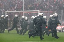 German riot police chase Cologne soccer supporters