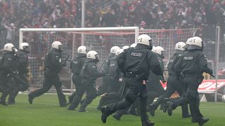 German riot police chase Cologne soccer supporters