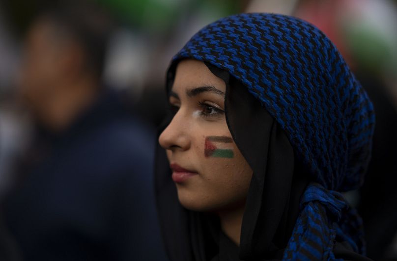 A woman displays the Palestinian flag drawn on her face during a pro-Palestinian march through downtown Hamilton, October 2023