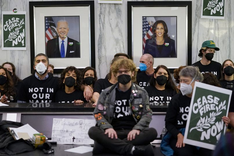 The portraits of US President Joe Biden and Vice President Kamala Harris are seen as demonstrators stage a sit-in demanding a cease-fire in Oakland, CA, October 2023