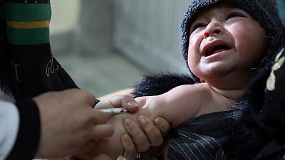A child receives a measles vaccine at the Indira Gandhi Children Hospital, in Kabul, Afghanistan, Monday, March 15, 2021.