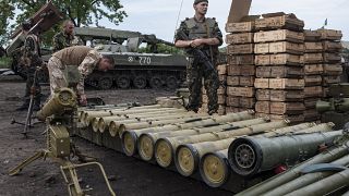 Ukrainian soldiers guard weapons captured in eastern Ukraine.