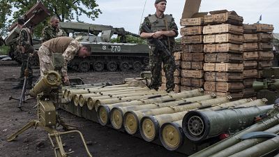 Ukrainian soldiers guard weapons captured in eastern Ukraine.