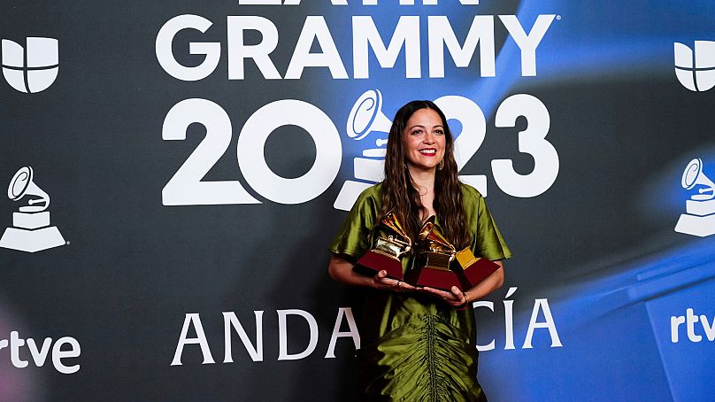Natalia Lafourcade poses in the press room with the awards for record of the year
