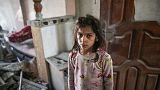 Palestinian Nada Abu Hayyya, 8, is seen in a demolished building after `an Israeli attack at Nuseirat refugee camp following the death of her mother and two siblings in Gaza