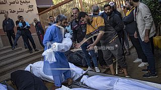 Palestinians mourn their relatives killed in the Israeli bombardment of the Gaza Strip, in the hospital in Khan Younis, Saturday, Nov. 18, 2023.