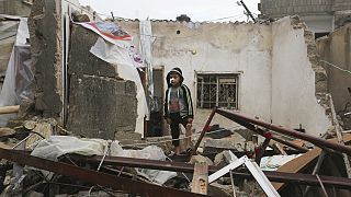 A Palestinian boy stands among the destruction after Israeli strikes on Rafah, Gaza Strip