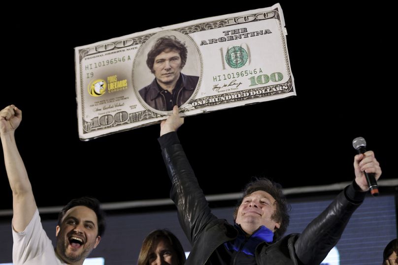 Javier Milei, Liberty Advances coalition presidential candidate, holds a cardboard image of a 100 US dollar bill bedecked with an image of his face in Cordoba, November 2023