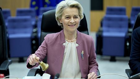 European Commission President Ursula von der Leyen rings a bell to signify the start of a meeting of the College of Commissioners at EU headquarters in Brussels.