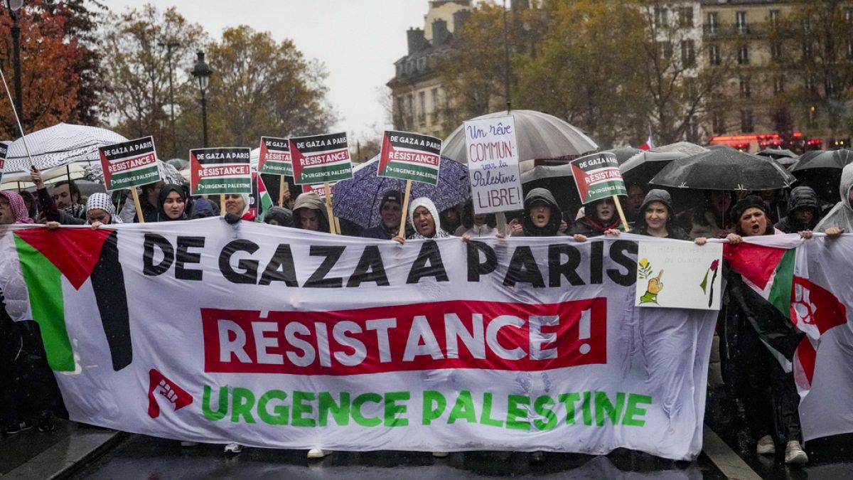 People chant slogans holding banners that reads "From Gaza to Paris - Residence - Emergency Palestine" during a pro-Palestinian rally, in Paris, Saturday, Nov. 18, 2023.