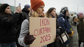 People, most of them ethnic Russians, gather in front of the Finnish parliament to protest against closure of the border crossing points with Russia, Saturday, Nov. 18, 2023.