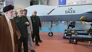 Supreme Leader Ayatollah Ali Khamenei, left, visits an exhibition of the Revolutionary Guard's aerospace achievements,  Iran, Sunday, Nov. 19, 2023