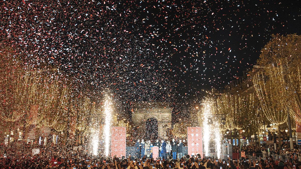 French actor Gilles Lellouche, center right, Paris mayor Anne Hidalgo, center left, and guests during the inauguration of the Champs Elysee Avenue illumination.