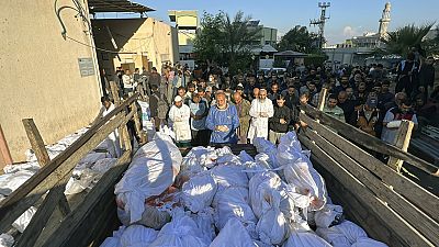 Palestinians pray over the bodies of people killed by Israeli airstrikes on Jabaliya refugee camp, at the Indonesian hospital, northern Gaza Strip, Saturday, Nov. 18, 2023. 
