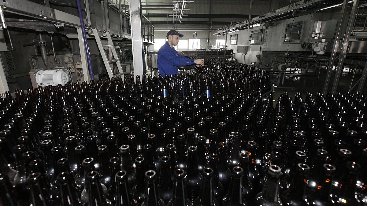 An employee works at a line bottling beer at Carlsberg brewery "Baltika-Pikra" factory in Krasnoyarsk, January 10, 2013. 