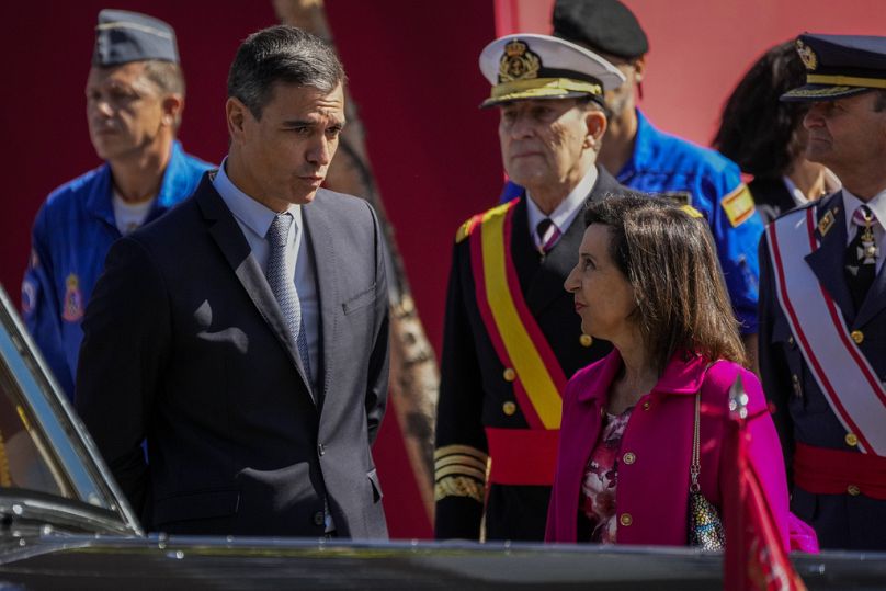 Spain's Prime Minister Pedro Sanchez, left, talks with Spain's Defense Minister Margarita Robles