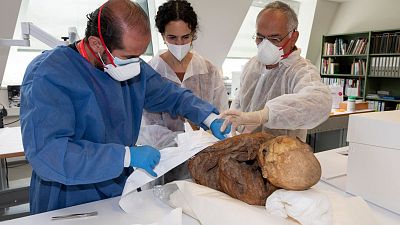 Archaeologists prepare one of three pre-Columbian mummies for transport to Bolivia.