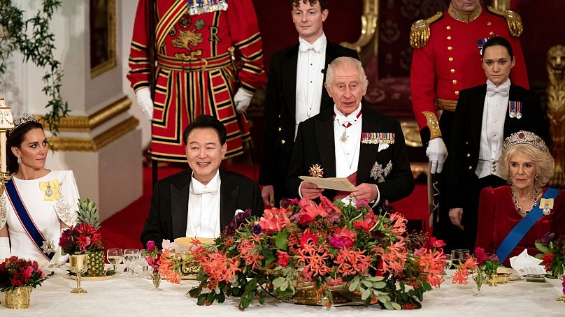 President of South Korea Yoon Suk Yeol listens as King Charles III speaks at the state banquet at Buckingham Palace