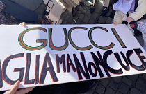 Gucci workers protest in Rome's Piazza del Popolo, with a sign saying "Gucci cuts but does not sew". Friday, 17 November 2023