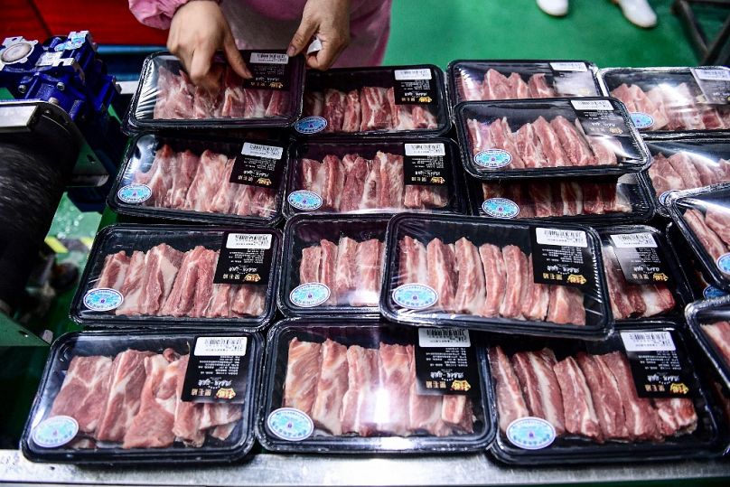 Cette photo prise le 16 septembre 2020 montre un ouvrier emballant du porc dans une usine de conditionnement de viande à Shenyang, dans la province chinoise du Liaoning