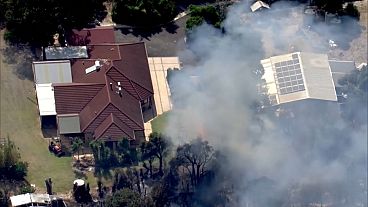 Bush fires destroy homes in northern Perth. 