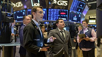 Traders work on the floor of the New York Stock Exchange during opening bell in New York City 