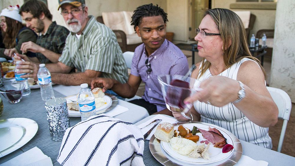 Why has this woman opened her home to strangers this Thanksgiving?