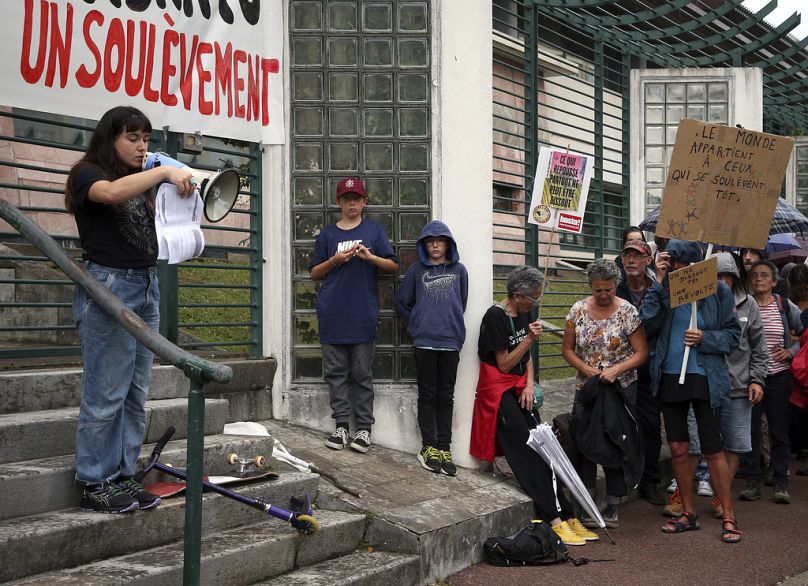 A protester delivers a speech in front of the sub-prefecture of Bayonne, June 2023