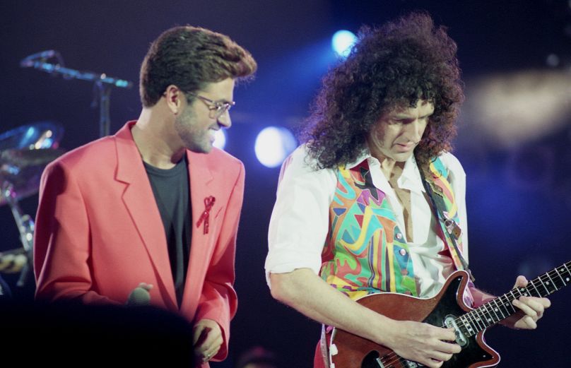 British singer George Michael, left, performs with "Queen" guitarist Brian May at the Freddie Mercury Tribute Concert at London's Wembley Arena, United Kingdom