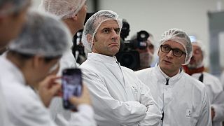 French President Emmanuel Macron (C) attends a visit to the Danish multinational pharmaceutical company Novo Nordisk in Chartres, central France, on November 23, 2023.