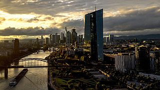 The sun sets over the buildings of the banking district and the European Central Bank, right, in Frankfurt, Germany, Friday, Oct. 20, 2023