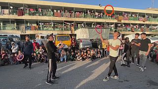 Acrobats entertain children at a school for displaced children in Rafah