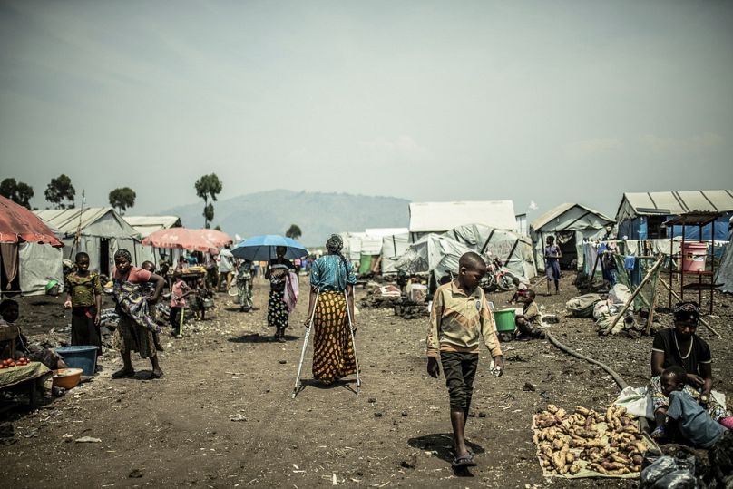 The 42-year-old mother of four who was raped walks in the Bulengo displacement camp where she had fled war in eastern DRC, August 2023