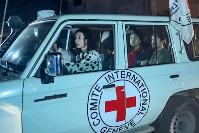 This image grab taken from an AFPTV video footage shows an International Red Cross vehicle reportedly carrying hostages released by Hamas crosses the Rafah border point