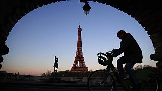 A man rides on a city bicycle in Paris, Monday, March 30, 2020.