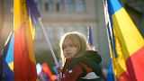 A little girl waves a flag during an anti-government and anti-restrictions protest organised by the far-right Alliance for the Unity of Romanians or AUR, in Bucharest.