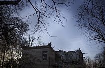 A Ukrainian serviceman stands atop a damaged kindergarten following a Russian drone attack in Kyiv, Ukraine, Saturday, Nov. 25, 2023.