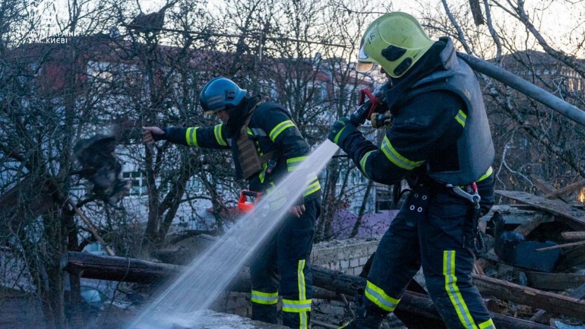 Rescuers working to extinguish a fire at the site of a drone attack in Kyiv, 25 November 2023
