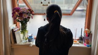 Journalist Simran Kathuria looks from her apartment window in Dublin