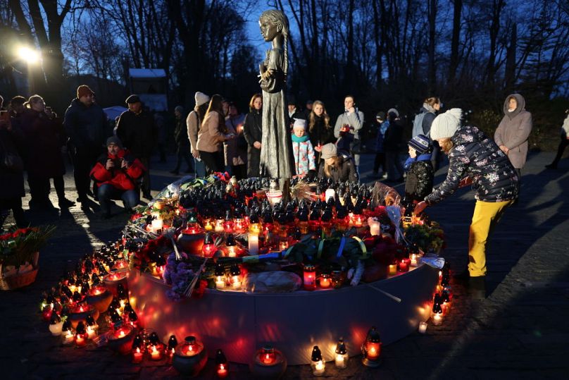 People honour the memory of millions of Ukrainians who died during the Great Ukrainians Famine organised by the Soviet regime near the monument to the victims of Holodomor