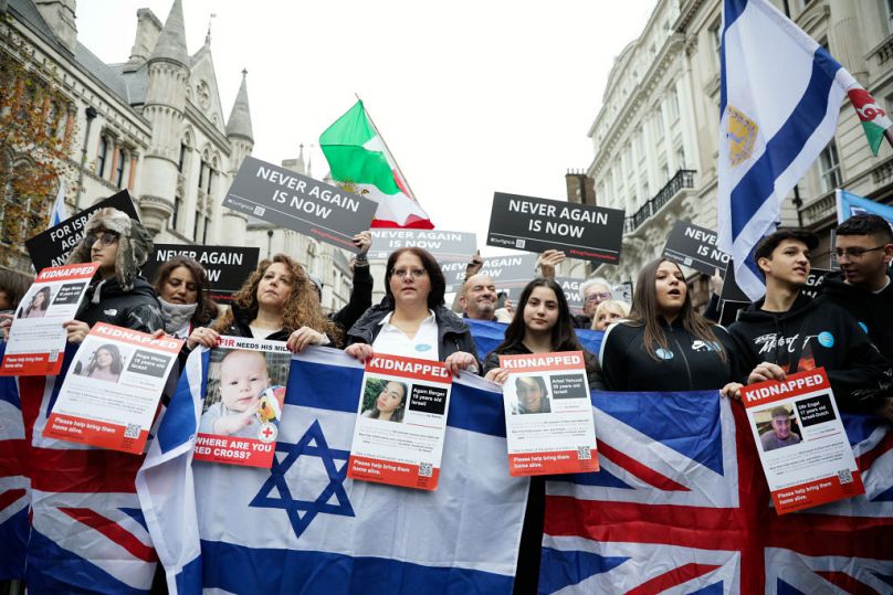Protestors hold banners as they march against anti-Semitism on Sunday in London, England