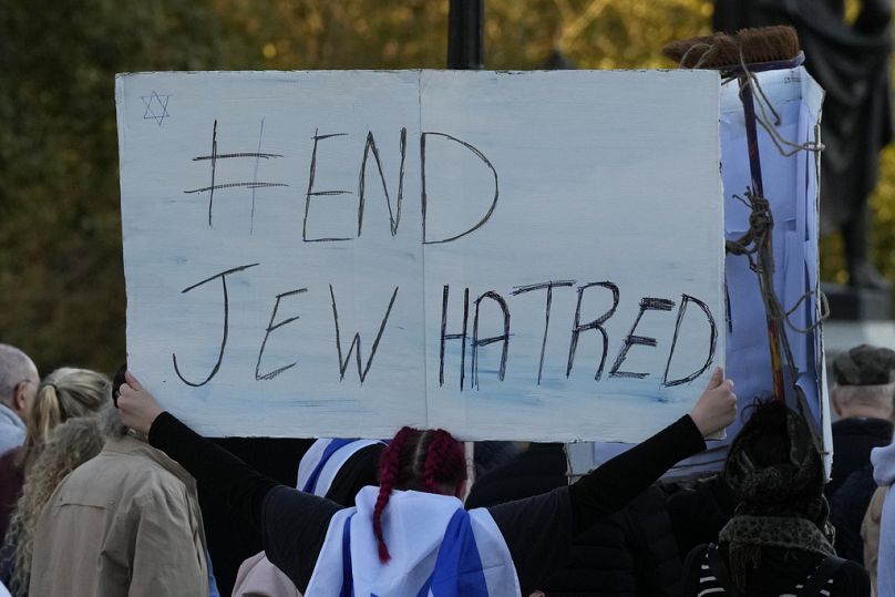 An Israeli supporter holds up a placard saying 'End Jew Hatred' as she takes part in a protest in London last month