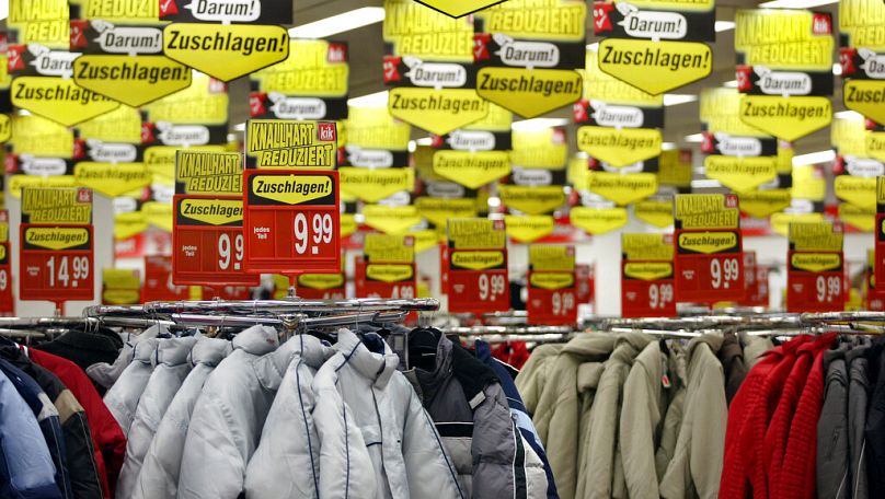 Advertising signs are seen in a branch of a clothing company in Duisburg, January 2006