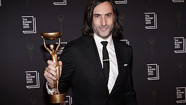 Irish writer Paul Lynch holds aloft the Booker Prize trophy for fiction at the London award ceremony, His fifth novel 'Prophet Song' was the judges top choice.  